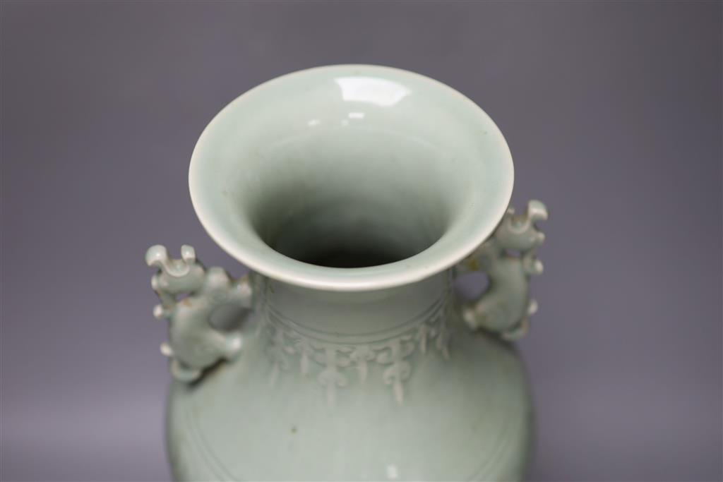 A Chinese green celadon glazed vase, with dragon handles, height 44cm (one re-glued handle)